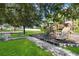 Community playground with a slide, climbing structure, benches, and green space at 16603 Corner Lake Dr, Orlando, FL 32820