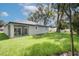 Expansive backyard features lush lawn, newly planted landscaping, and an outdoor patio at 1868 14Th St, Orange City, FL 32763