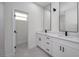 Bright bathroom featuring double vanity, modern sconces and faucets at 1868 14Th St, Orange City, FL 32763