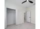 Bright bedroom featuring a ceiling fan, closet, and ensuite bathroom at 1868 14Th St, Orange City, FL 32763