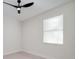 Neutral bedroom with a modern ceiling fan and window with privacy blinds at 1868 14Th St, Orange City, FL 32763