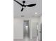 Bright bedroom featuring a modern ceiling fan, neutral walls, and two doorways at 1868 14Th St, Orange City, FL 32763