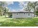 Back exterior elevation features a covered patio and well manicured lawn at 1868 14Th St, Orange City, FL 32763