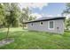 Rear view of a home with manicured lawn at 1868 14Th St, Orange City, FL 32763