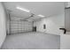 View of an oversized garage with epoxy flooring, overhead lighting, and a modern aluminum door at 1868 14Th St, Orange City, FL 32763