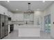 Beautiful kitchen with white cabinets, stainless steel appliances, and a modern pendant light at 1868 14Th St, Orange City, FL 32763