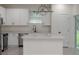 Bright, newly renovated kitchen with white cabinets, a center island, and stainless steel appliances at 1868 14Th St, Orange City, FL 32763
