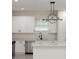 Beautiful kitchen with white cabinetry, stainless steel appliances and stylish modern lighting at 1868 14Th St, Orange City, FL 32763