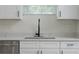Modern kitchen featuring white cabinets, black hardware, quartz countertops, and stainless steel appliances at 1868 14Th St, Orange City, FL 32763