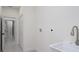 Bright Laundry room featuring a large white sink, silver faucet and access to a hallway at 1868 14Th St, Orange City, FL 32763