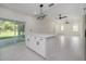 Open-concept living space features tile flooring, neutral paint, and a kitchen island at 1868 14Th St, Orange City, FL 32763