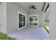 A covered outdoor patio features painted concrete floors, a ceiling fan, and sliding glass doors at 1868 14Th St, Orange City, FL 32763
