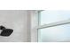 Shower with stylish gray tile, modern shower head, and frosted window at 1868 14Th St, Orange City, FL 32763