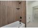 Shower featuring wood paneling and modern matte black fixture at 1868 14Th St, Orange City, FL 32763