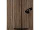 Close-up of matte black shower head against wood paneled wall at 1868 14Th St, Orange City, FL 32763