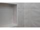 Shower features modern geometric-patterned gray tile, complemented by a convenient built-in niche at 1868 14Th St, Orange City, FL 32763