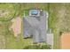Aerial shot showcasing the home's roof, pool area, and horse-training features at 19630 County Road 455, Clermont, FL 34715