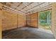 View of a barn stall with wood walls and a rubber matted floor at 19630 County Road 455, Clermont, FL 34715