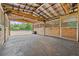 Well-maintained barn interior featuring wooden stalls and fans for ventilation at 19630 County Road 455, Clermont, FL 34715