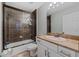 Bathroom features a shower-over-tub, tile surround, vanity with granite countertop, and ample natural light at 19630 County Road 455, Clermont, FL 34715