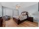 Comfortable bedroom featuring wood floors, a ceiling fan, closet, and a cozy chair at 19630 County Road 455, Clermont, FL 34715
