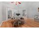 Breakfast nook with white table, chairs, and natural light from the french doors at 19630 County Road 455, Clermont, FL 34715