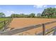 A horse arena with a wooden fence and well-maintained grounds at 19630 County Road 455, Clermont, FL 34715