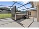Outdoor hot tub with a retractable cover, set on a spacious patio with a screened enclosure at 19630 County Road 455, Clermont, FL 34715