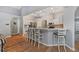 Bright kitchen boasts bar seating, white cabinetry, and stainless steel appliances at 19630 County Road 455, Clermont, FL 34715