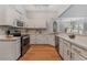 Bright kitchen features white cabinetry and modern stainless steel appliances at 19630 County Road 455, Clermont, FL 34715