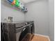Laundry room with modern washer and dryer, and convenient shelving for storage at 19630 County Road 455, Clermont, FL 34715