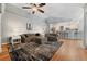 Open-concept living room features hardwood floors and flows seamlessly into the modern kitchen with bar seating at 19630 County Road 455, Clermont, FL 34715
