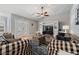 Comfortable living room with hardwood floors and a ceiling fan, perfect for relaxing and entertaining guests at 19630 County Road 455, Clermont, FL 34715