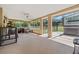 Large enclosed patio offers comfortable seating, hot tub, and scenic views of the outdoors at 19630 County Road 455, Clermont, FL 34715