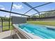Swimming pool for exercise in a screened-in outdoor area with views of the property at 19630 County Road 455, Clermont, FL 34715