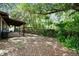 Private backyard featuring a covered patio, wooden fence, and mature trees at 206 Gerry Dr, Altamonte Springs, FL 32714