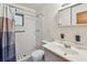 Cozy bathroom featuring a tiled shower, white vanity with sink, toilet and a mirrored medicine cabinet at 206 Gerry Dr, Altamonte Springs, FL 32714