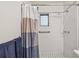 Shower space with tiled walls, safety bar, shower head and curtain in a well lit bathroom at 206 Gerry Dr, Altamonte Springs, FL 32714