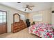 Comfortable bedroom with a floral bedspread, dresser, and natural light coming from the windows at 206 Gerry Dr, Altamonte Springs, FL 32714