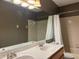 Bathroom featuring a double vanity with white countertops and tiled walls with a bathtub with shower curtain at 2061 Piedmont Park Blvd, Apopka, FL 32703