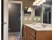 Bathroom features a double vanity with a white countertop and wooden cabinets with tiled floors at 2061 Piedmont Park Blvd, Apopka, FL 32703