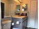 Well-lit bathroom featuring a single vanity, mirror and commode with a built-in cabinet and a toilet paper holder at 2061 Piedmont Park Blvd, Apopka, FL 32703
