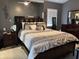 Large bedroom with a king size bed and dark wood furniture and decor provides a comfortable retreat at 2061 Piedmont Park Blvd, Apopka, FL 32703