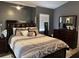 Spacious bedroom features a king bed, dark wood furniture and lots of natural light from the window at 2061 Piedmont Park Blvd, Apopka, FL 32703