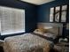 Bedroom features a large window with blinds and a comfortable bed with a patterned comforter at 2061 Piedmont Park Blvd, Apopka, FL 32703