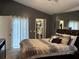 Serene bedroom featuring a king bed, mirrored wall, and closet, offering ample storage and a relaxing atmosphere at 2061 Piedmont Park Blvd, Apopka, FL 32703
