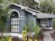 Stylish home showcasing an arched window, decorative columns, and lush landscaping for enhanced curb appeal at 2061 Piedmont Park Blvd, Apopka, FL 32703