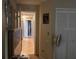 Hallway view showing a bedroom closet and an entrance to another room with tiled floors throughout at 2061 Piedmont Park Blvd, Apopka, FL 32703