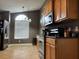 Well-lit kitchen featuring stainless steel appliances, natural wood cabinets, and modern lighting fixtures at 2061 Piedmont Park Blvd, Apopka, FL 32703