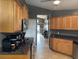 Cozy kitchen featuring wooden cabinets, granite countertops, and modern appliances, providing a functional space at 2061 Piedmont Park Blvd, Apopka, FL 32703